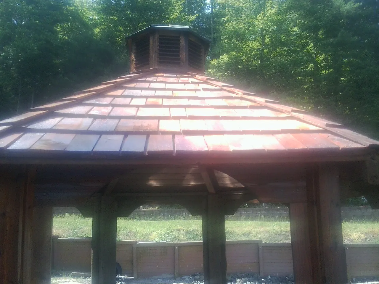 New cedar shake roof and cupola on a lakeside gazebo in Dalzell