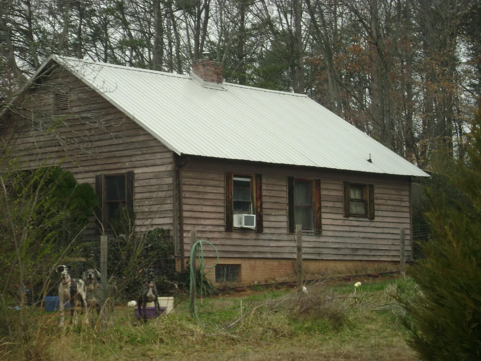 White metal roof on an old wood sided farmhouse, from a Metal Roof Installation job in Dalzell